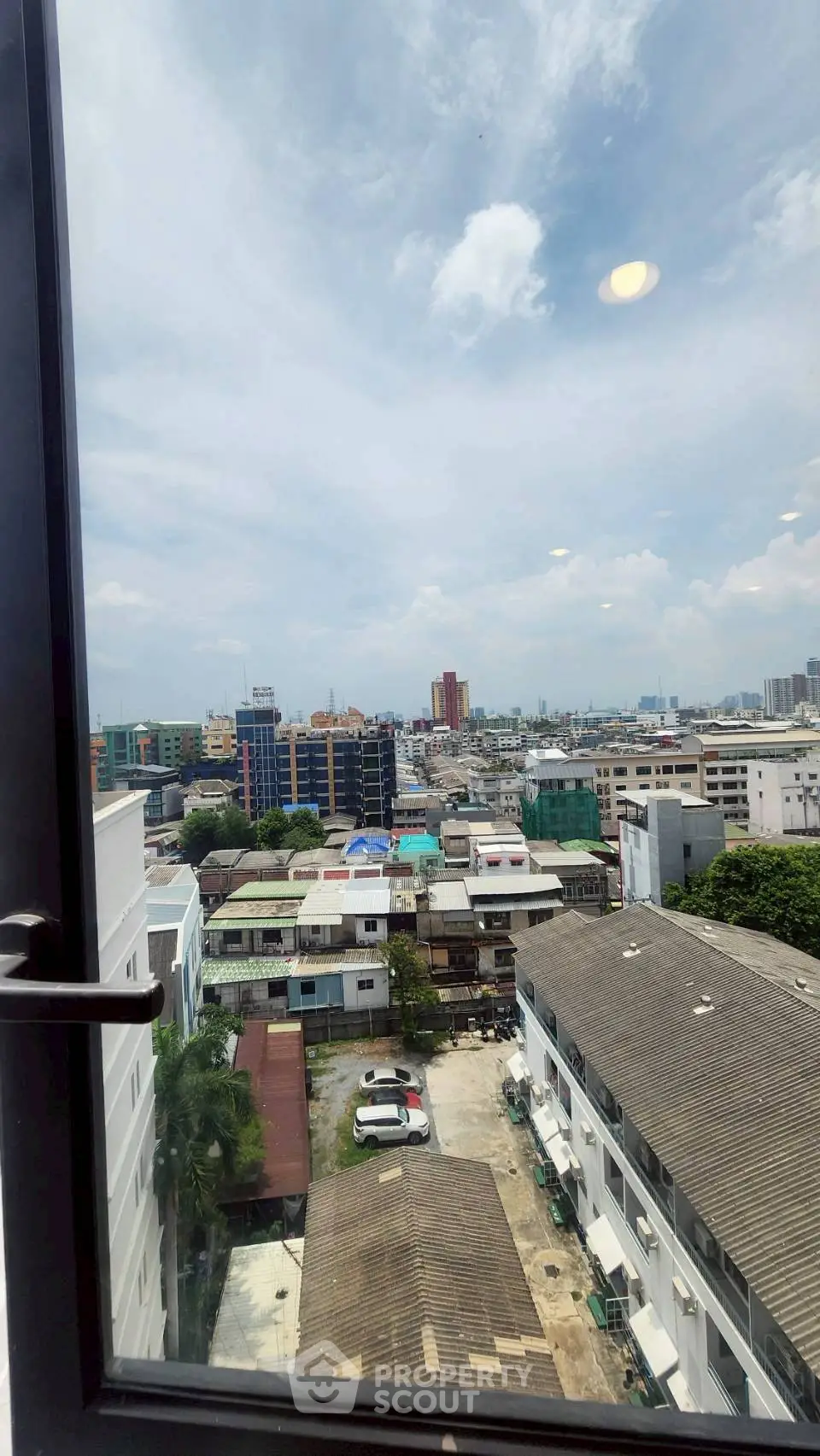 Stunning cityscape view from a high-rise window showcasing urban living.