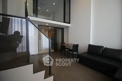 Modern duplex living room with sleek staircase and stylish furniture