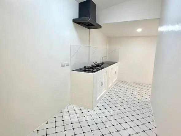 Modern minimalist kitchen with sleek gas stove and white tiled flooring