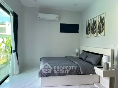 Modern bedroom with large window and stylish decor