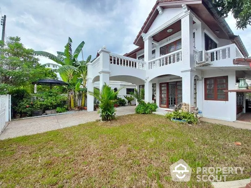 Charming two-story house with lush garden and spacious balcony in serene neighborhood.