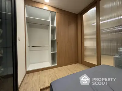 Modern bedroom with built-in wardrobe and wooden flooring