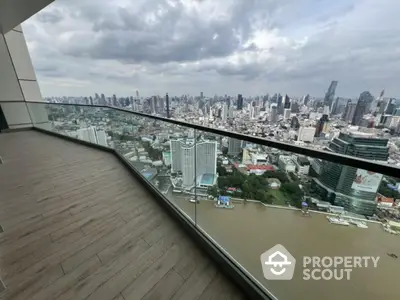 Stunning cityscape view from a modern high-rise balcony overlooking the river.