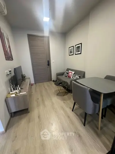 Modern living room with stylish furniture and wooden flooring in a cozy apartment.