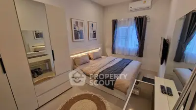 Modern bedroom with stylish decor, featuring a cozy bed, sleek wardrobe, and ambient lighting.