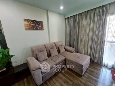 Cozy living room with plush sectional sofa and elegant curtains