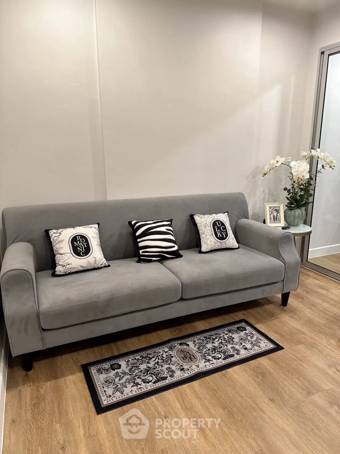 Stylish living room with modern gray sofa and elegant decor