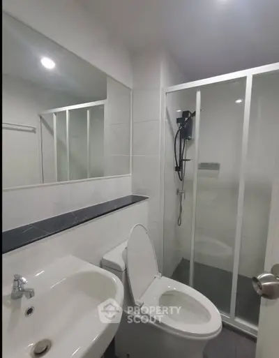 Modern bathroom with sleek shower and elegant fixtures in a contemporary apartment.