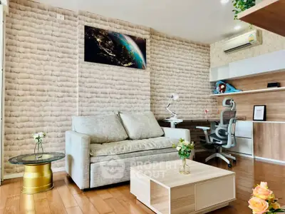 Modern living room with stylish decor and workspace, featuring cozy sofa and elegant wooden flooring.