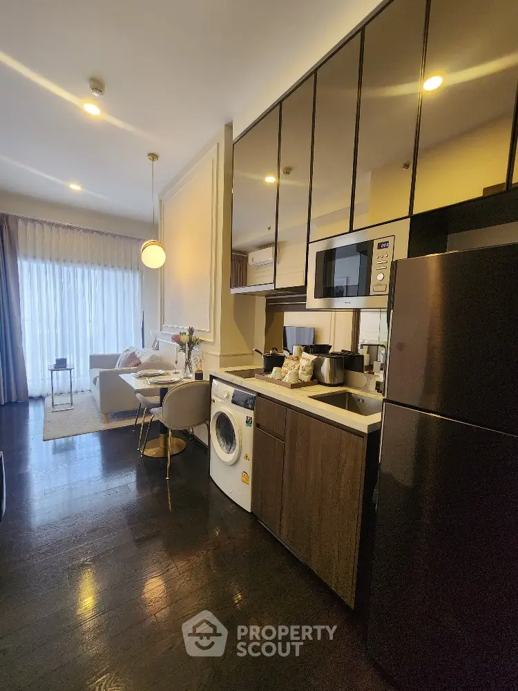 Modern open-layout kitchen with sleek appliances and cozy living area