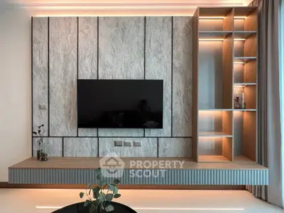 Modern living room with sleek TV wall unit and ambient lighting