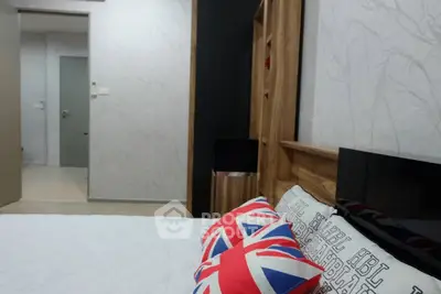 Modern bedroom with stylish decor and Union Jack pillows, featuring sleek wooden furniture and neutral tones.