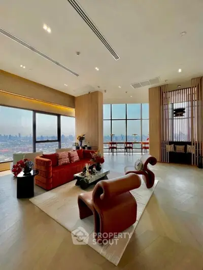 Luxurious modern living room with panoramic city views and stylish furniture.