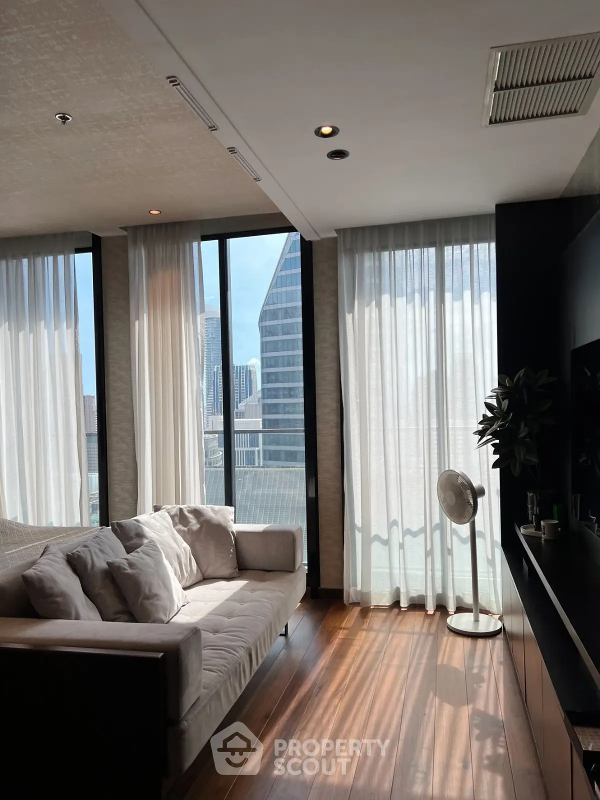 Luxurious living room with floor-to-ceiling windows and stunning city view