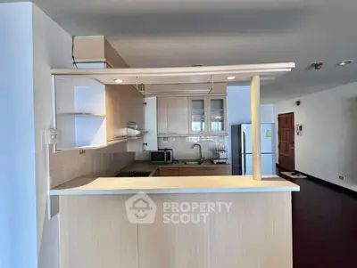 Spacious kitchen with open layout and modern appliances in a stylish apartment.