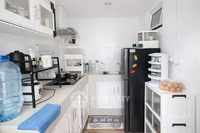 Compact kitchen with modern appliances and sleek storage solutions.