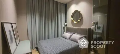 Elegant bedroom with modern design, featuring a stylish bed with patterned bedding, sleek floor-to-ceiling curtains, and a unique wall mirror.