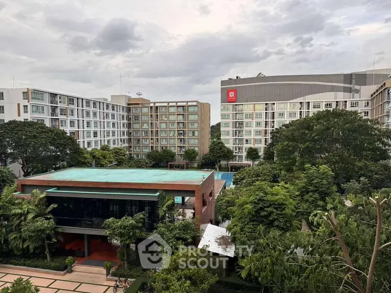 Modern residential complex with lush greenery and pool view, perfect for urban living.