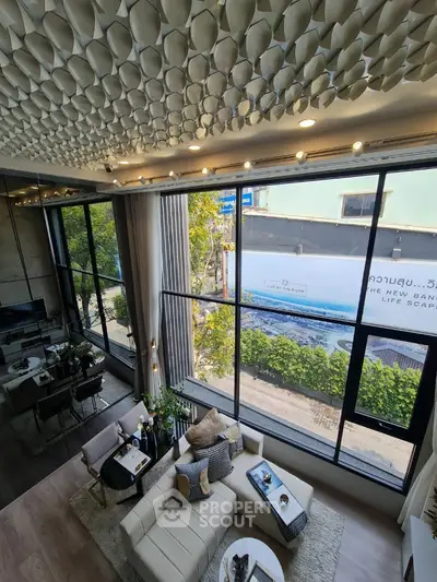 Luxurious modern living room with high ceiling and large windows