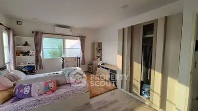 Spacious bedroom with modern decor and ample natural light