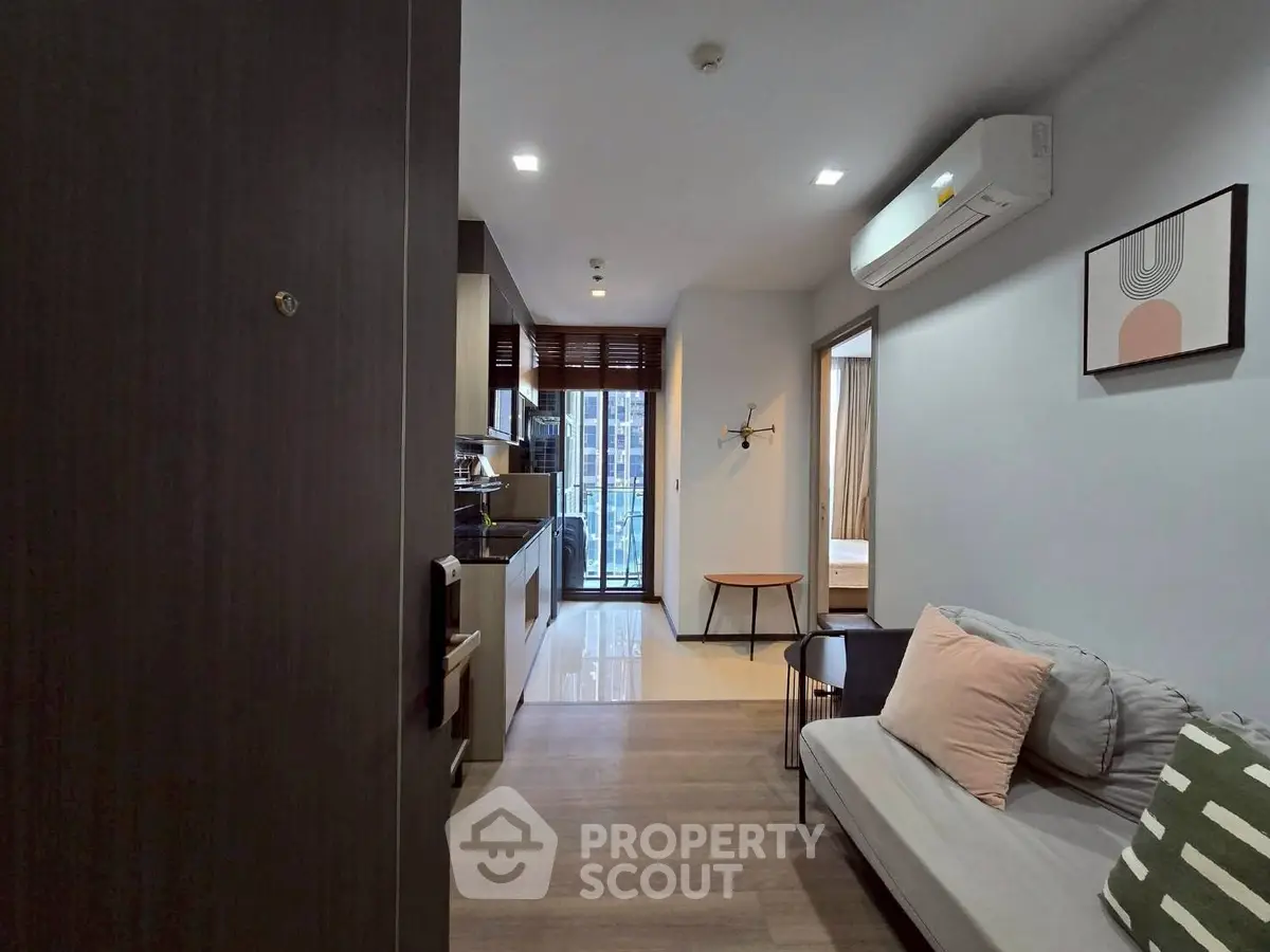 Modern apartment interior with cozy living room and kitchen, featuring sleek design and natural light.