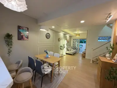 Stylish open-plan living and dining area with modern decor and cozy ambiance.