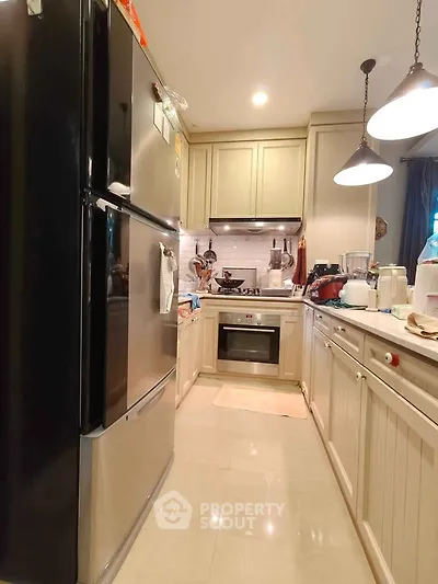 Modern kitchen with stainless steel appliances and elegant cabinetry.
