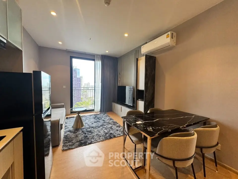 Modern living room with stylish furniture and city view balcony in a luxury apartment.