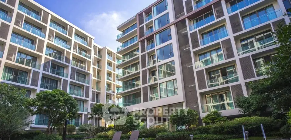 Modern apartment building with lush garden and large windows