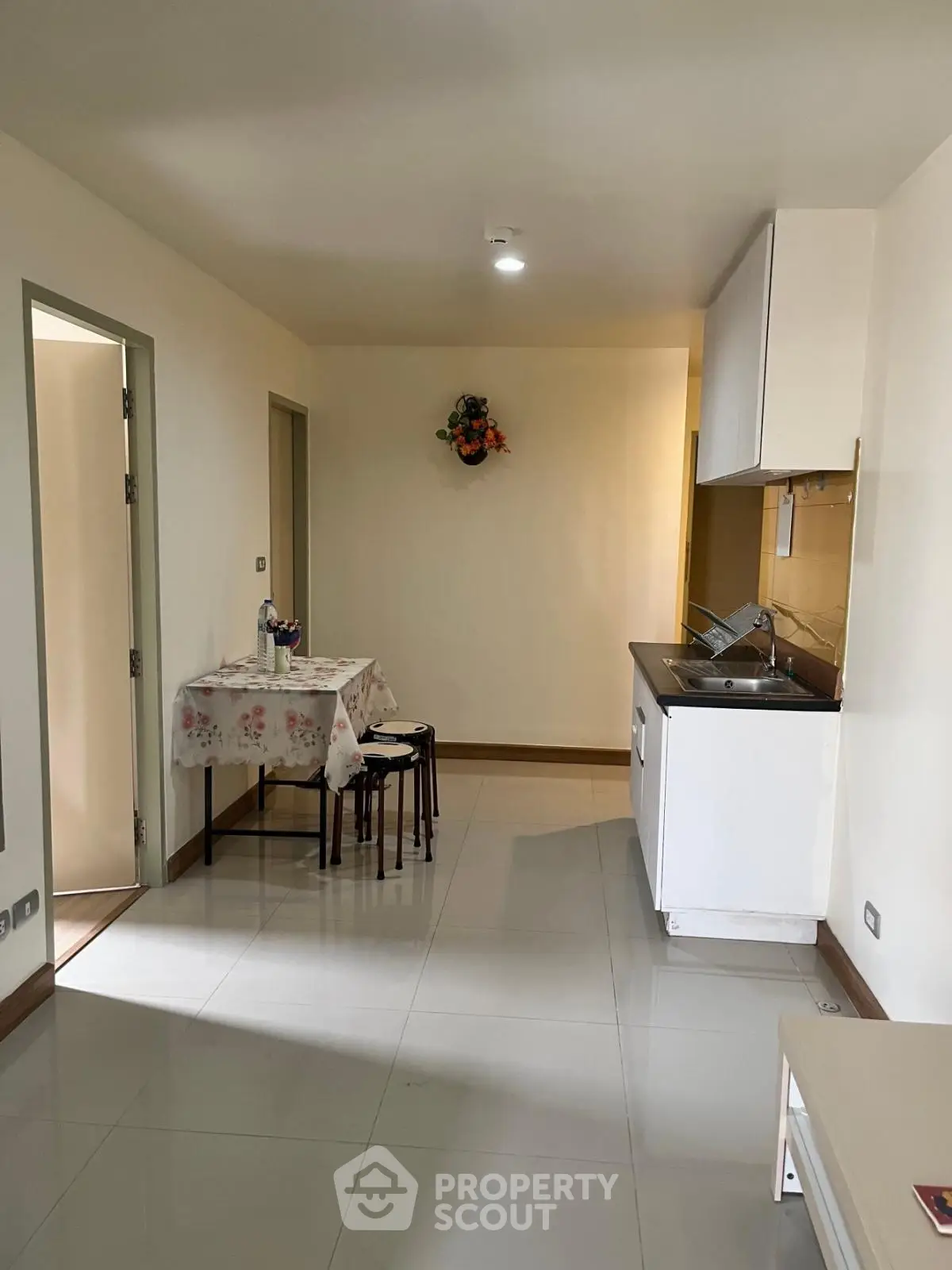 Cozy compact kitchen with dining area in modern apartment