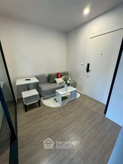 Cozy living room with modern decor and compact furniture in a stylish apartment.