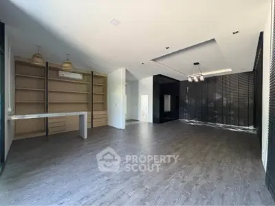Spacious modern living room with elegant flooring and built-in shelves