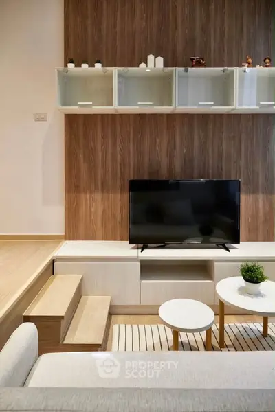 Modern living room with stylish wooden wall paneling and sleek TV setup