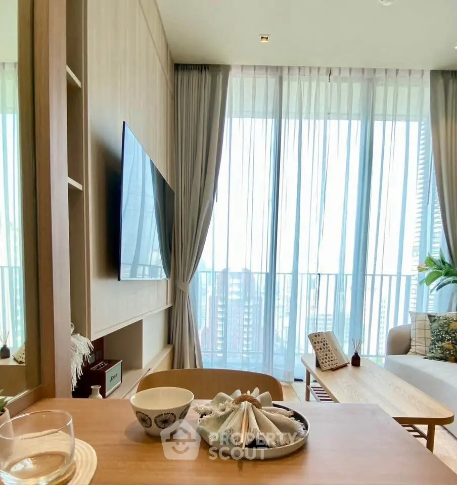 Modern living room with floor-to-ceiling windows and stylish decor in a high-rise apartment.