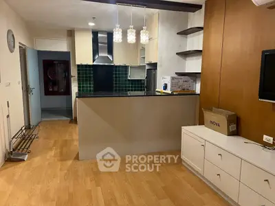 Modern kitchen with open layout and stylish lighting in a cozy apartment.