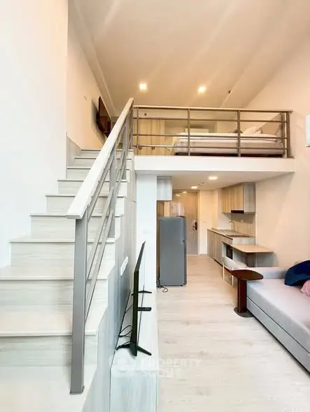 Modern loft apartment with mezzanine bedroom and sleek open kitchen design.