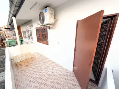 Charming balcony with tiled flooring and air conditioning unit, perfect for relaxation.