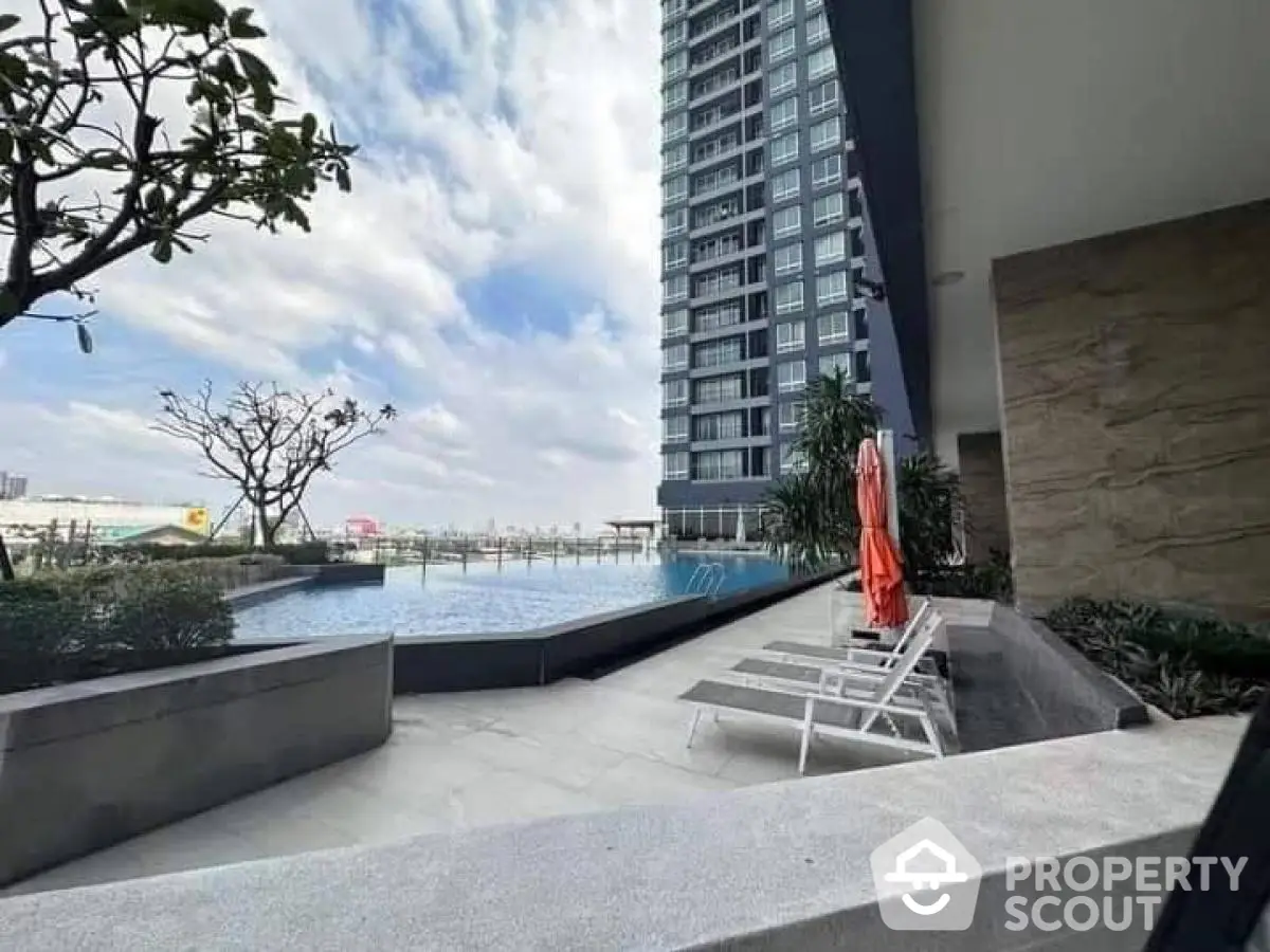 Luxurious high-rise building with stunning poolside view and modern amenities.