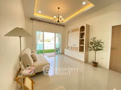 Modern living room with elegant chandelier and garden view