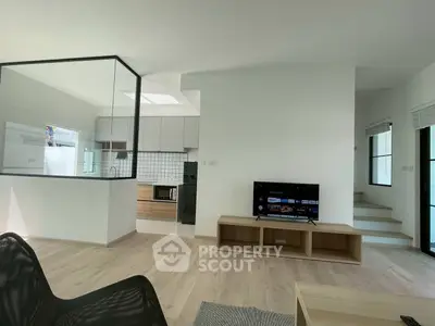 Modern open-plan living room with sleek kitchen and stylish decor