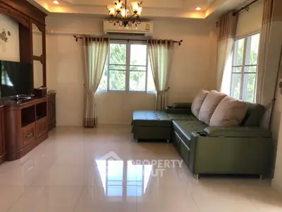 Spacious living room with elegant decor and large windows for natural light