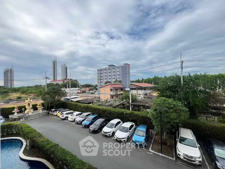 Scenic view of urban landscape with parking and pool area