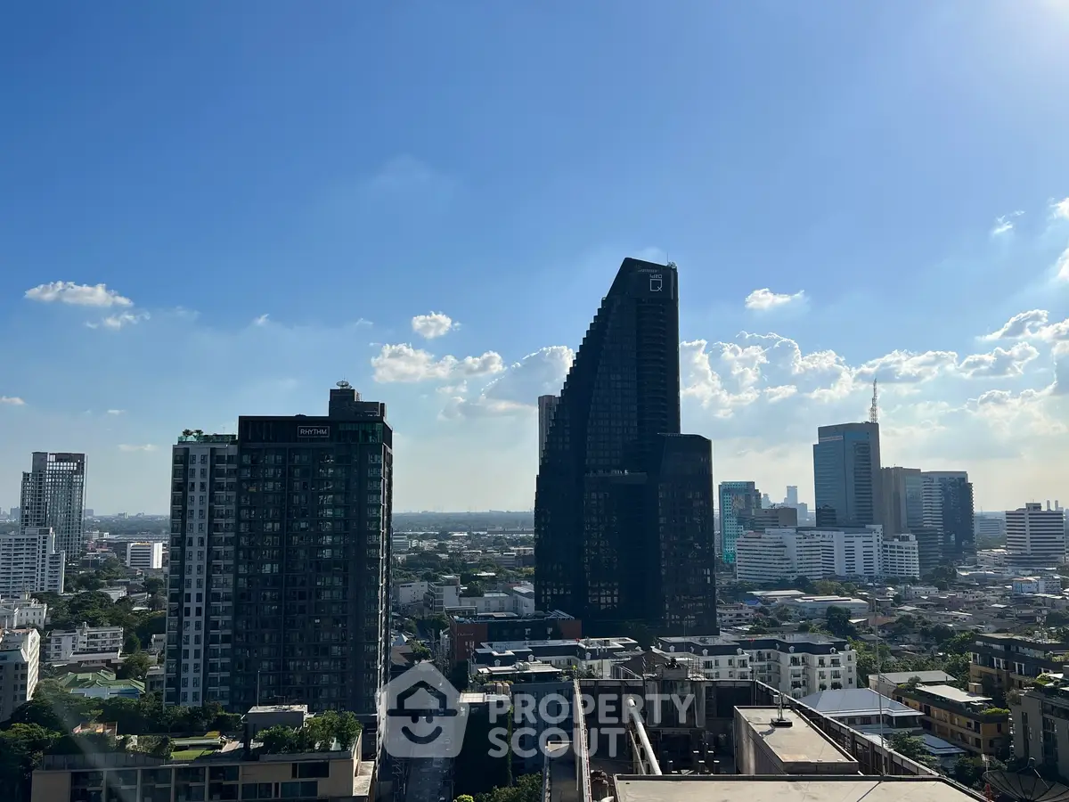 Stunning cityscape view with modern skyscrapers under a clear blue sky, showcasing urban living at its finest.