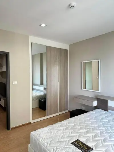 Modern bedroom with sleek wardrobe and cozy bed in stylish apartment