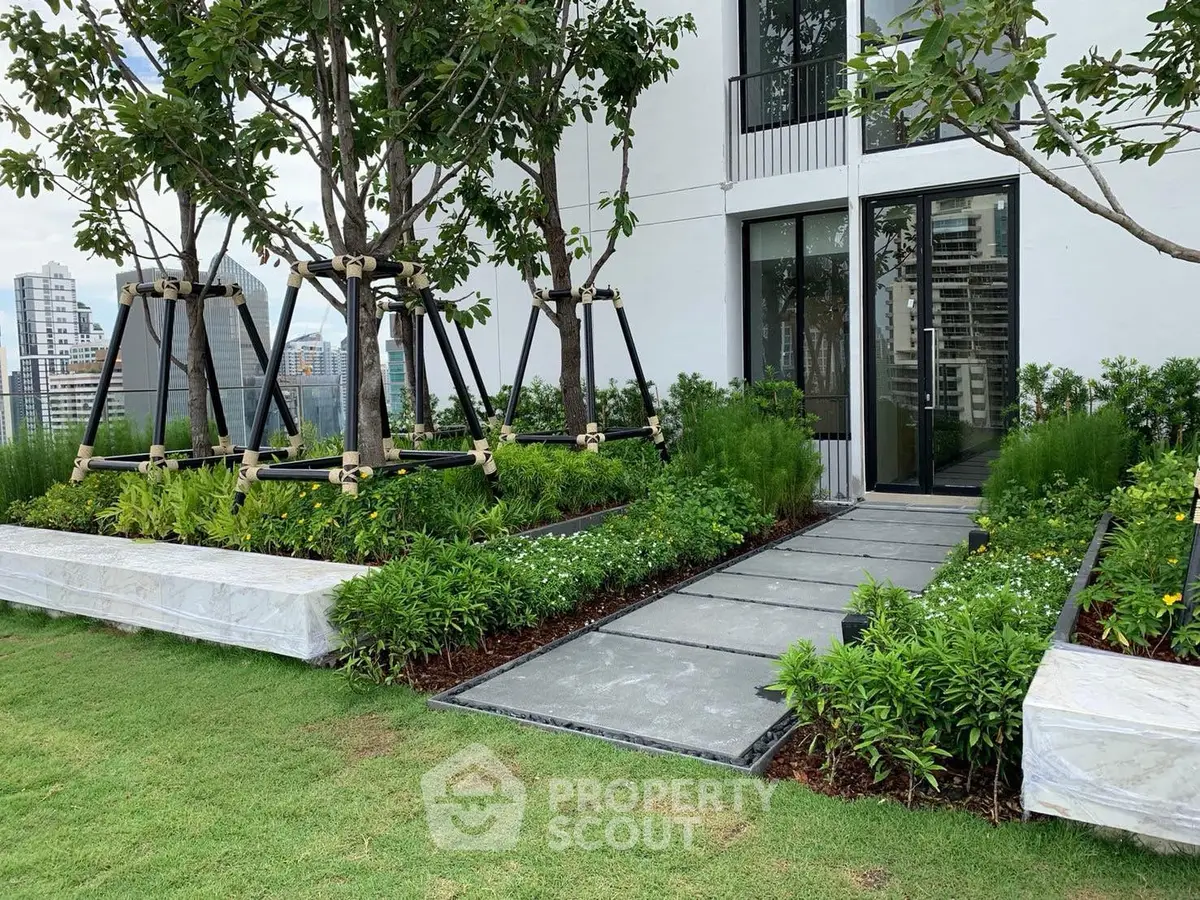 Luxurious garden entrance with lush greenery and city view