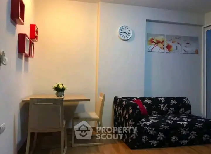 Cozy living room with floral sofa and modern decor in a stylish apartment.