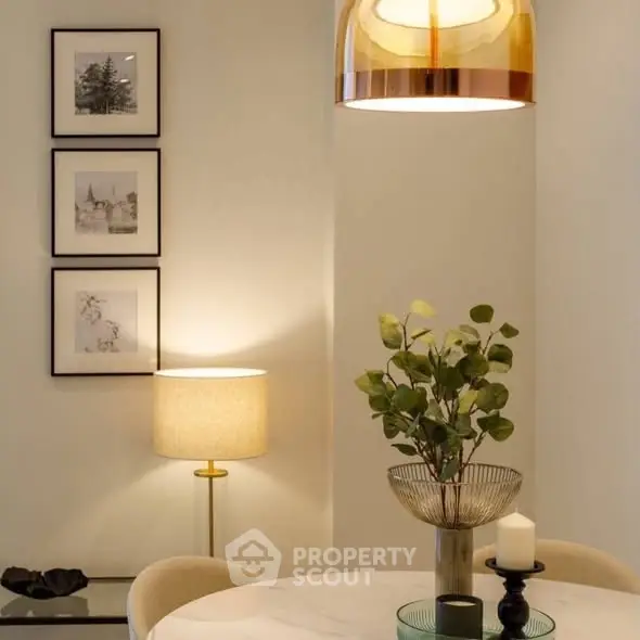 Elegant dining area with modern lighting and stylish decor in a cozy apartment.