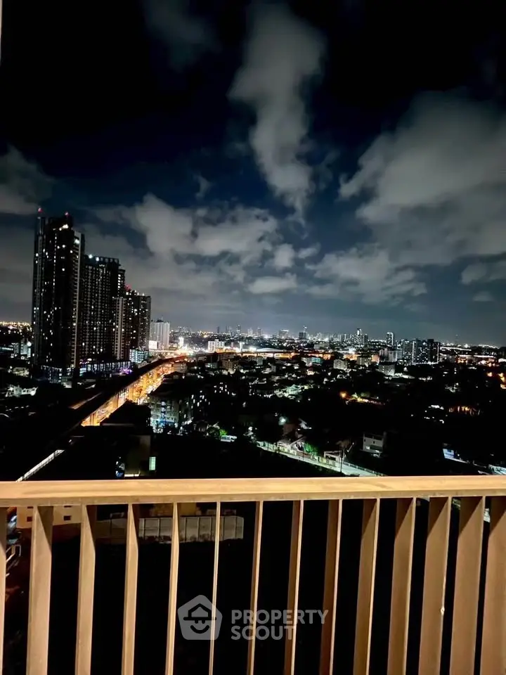 Stunning night cityscape view from a high-rise balcony, showcasing vibrant city lights and skyline.