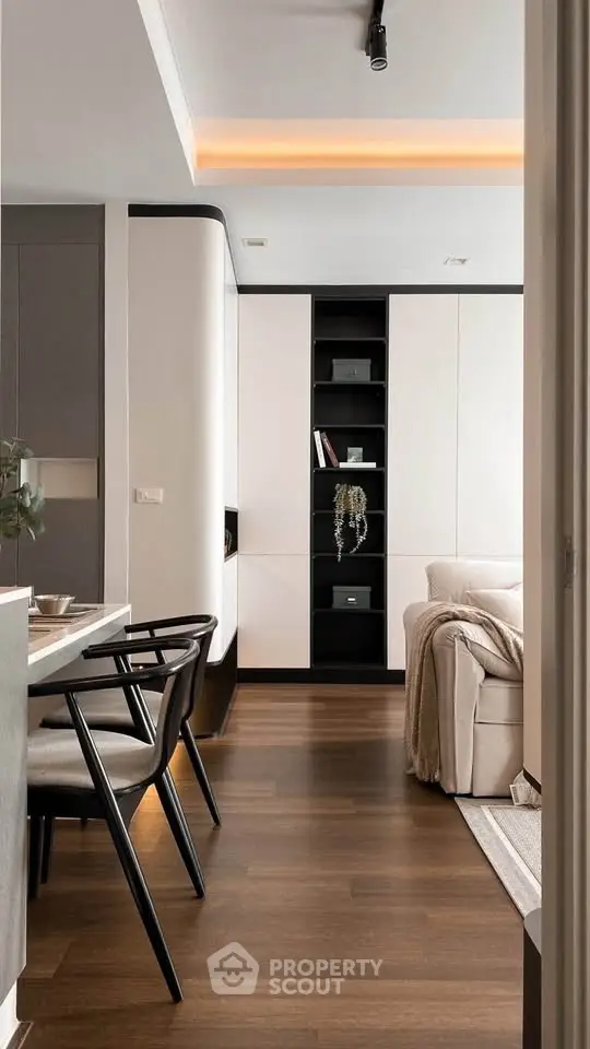 Modern living room with sleek furniture and elegant decor, featuring a cozy sofa and stylish dining area.