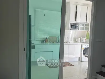 Modern kitchen with sleek white cabinets and built-in appliances